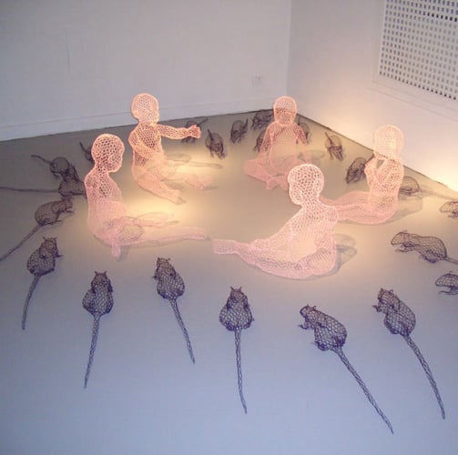 lit sculpture of babies and rats