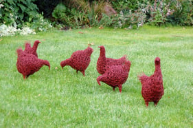 wire sculpture of chickens on lawn